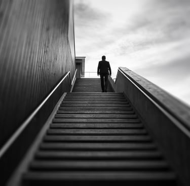 looking up at a man climbing a staircase