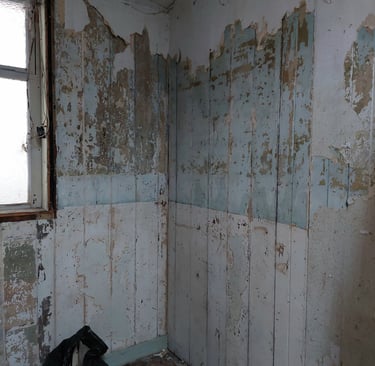 distressed wooden panelling with flaking paintwork