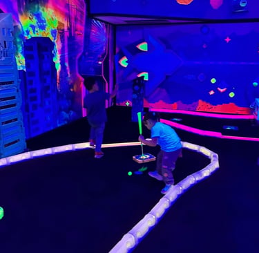 Kids playing glow-in-the-dark mini golf at Yum Yum Fun birthday party, Plymouth PA