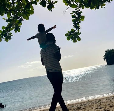 Father and son enjoying a walk at Grand Anse Beach