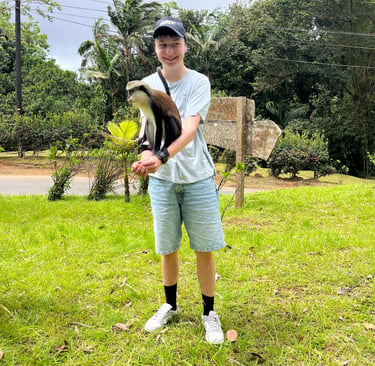 Young tourist enjoying the Mona Monkey - Grenada's wildlife