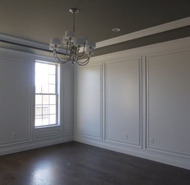 Dining room wall panels, crown molding, and custom architectural trim
