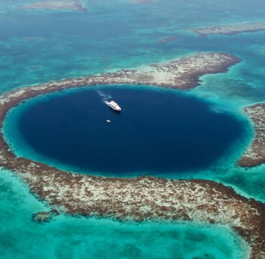 a boat in the middle of a large blue hole