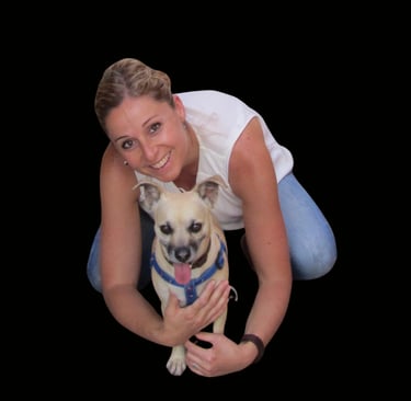 a woman holding a dog and smiling