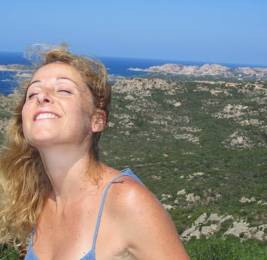 a woman in a blue dress is smiling and looking up at the sky