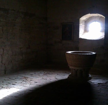 a stone urn in a stone wall with a window