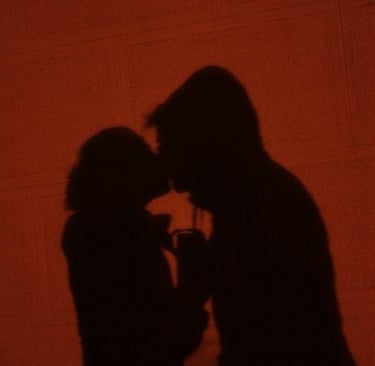 a man and woman kissing in a dark room