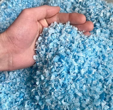 Gros plan sur du broyât de plastique PEHD recyclé bleu