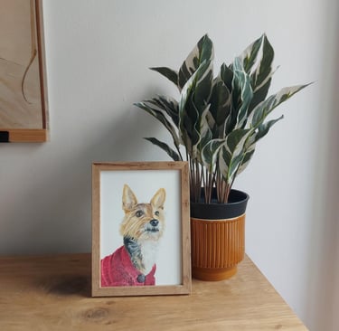 A5 framed realistic colored pencil drawing of a dog portrait next to a plant