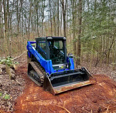 Skid Steer Clearing a path through the woods