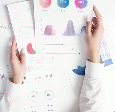 Professional analyzing financial data reports with colorful charts and business infographics.