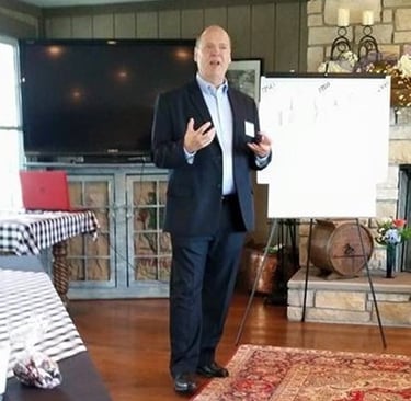 a man in a suit and tie standing in front of a white board