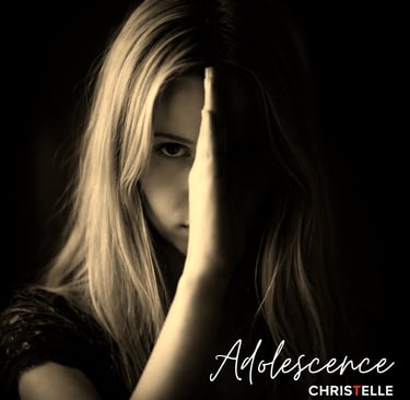 A moody, sepia-toned portrait of a young blonde woman with her face partially hidden by her hand.