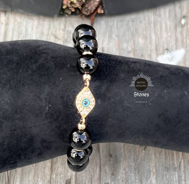 Obsidian beaded evil eye bracelet with gold accents and sparkling crystals for spiritual protection.