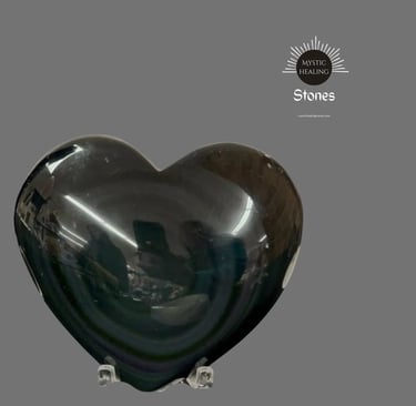 Polished black obsidian heart stone for healing and meditation on a clear stand.