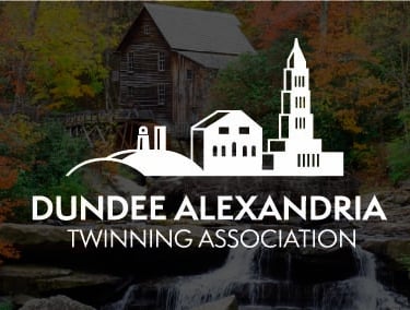 Dundee Alexandria Twinning Association logo over a scenic waterfall and historic rustic grist mill in autumn.