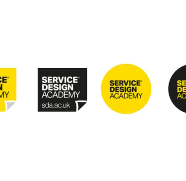 Service Design Academy logos in yellow and black circular and square shapes with website url.