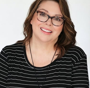 a woman with glasses and a necklace on her neck
