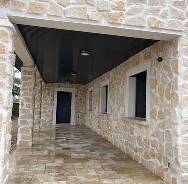 a stone building with a black door and a black door