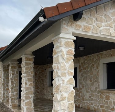 a house with a stone wall and a brick wall
