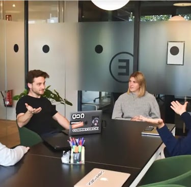 Team meeting with diverse professionals discussing marketing strategies around a table.