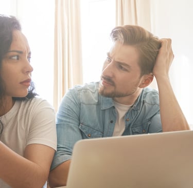 couple researching prices and arguing what if they under price their highlands ranch home for sale