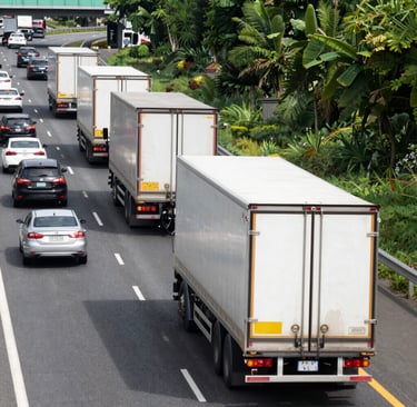 A sleek Bravex Transport truck parked at a bustling European port under a clear sky.