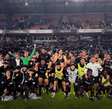 Académica de Coimbra football team celebrating a victory with their supporters