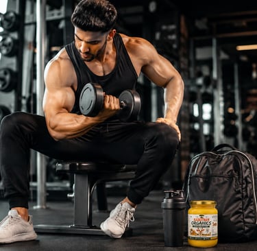Muscular man working out in a modern gym with a Rajasthan Organics A2 Bilona Ghee jar placed beside