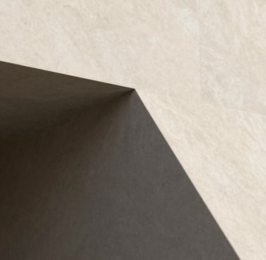 A minimalist architectural detail of a sharp corner where soft sand-colored stone (#F9F7F2) meets deep charcoal shadows (#333333). Minimalist and clean aesthetic.