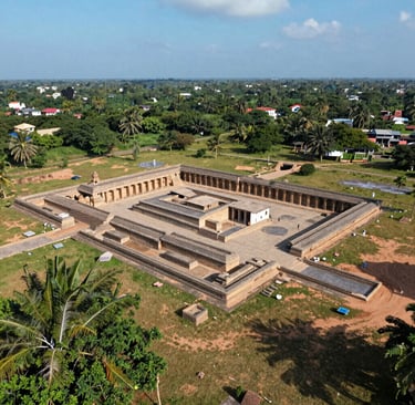 A vibrant gokart speeding around a sharp corner at GK Kart Kingdom in Keeladi, with lush greenery in the background.