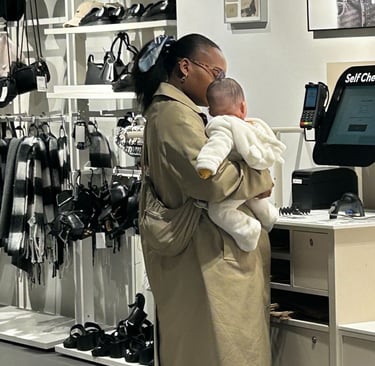 mum holding her baby in a shop