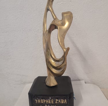 a bronze sculpture of a woman holding a flower