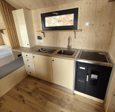 Tiny house kitchen with wooden wall