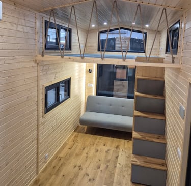 Tiny house living place with staircase and loft