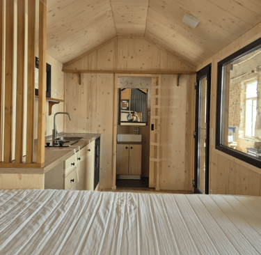 Tiny house kitchen surface on the left and on the front bathroom