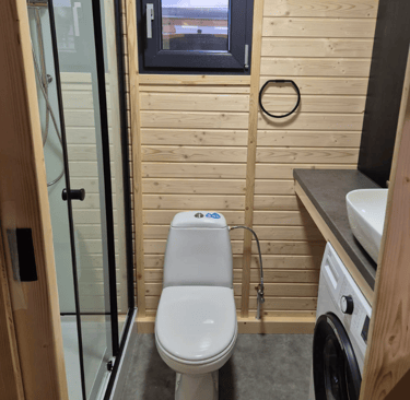Tiny house bathroom shower, toilet with washing machine