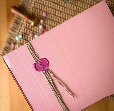 Elegant pink gift box sealed with a decorative pink flower wax stamp , ideal for festive gifting