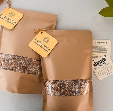 Two sealed recyclable brown paper bags filled with handcrafted panjeeri.