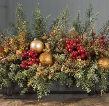 A festive winter porch planter featuring evergreens, painted branches, and refreshed pine cones.