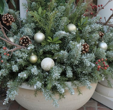 A winter porch planter filled with evergreens, painted branches, and refreshed pine cones for a fest