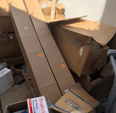 A big pile of card board boxes