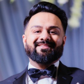 a man in a tuxedo suit and bow tie
