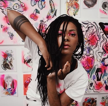 Artist with black braids posing in front of a wall of colorful street art and spray-painted illustrations.