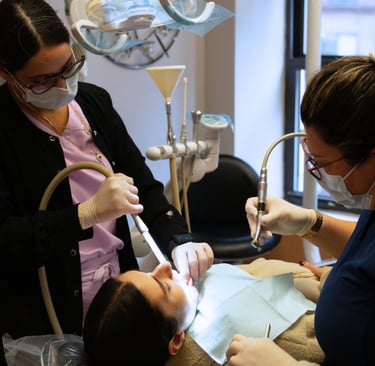 Dentist and dental assistant performing a dental procedure in Times Square, New York
