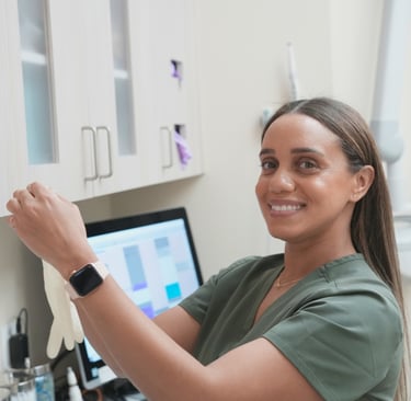 Dental hygienist reviewing patient for a cleaning in a dental office