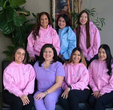 Dental care team posing together in a professional dental office in Manhattan and Queens, New York