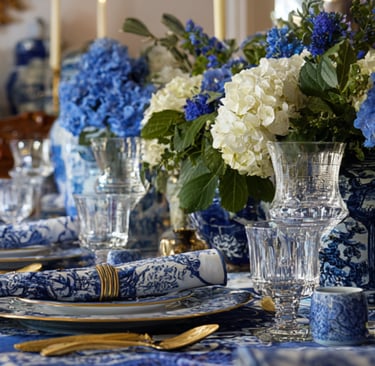a table setting with blue and white plates and blue and white plates