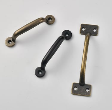 Vintage style cabinet pull handles in antique brass and matte black finishes for drawer hardware.