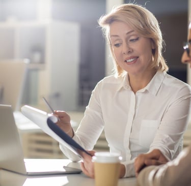 a woman sitting at a table with a man in a white shirt